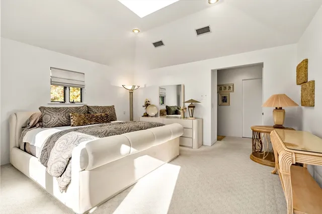 a spacious bedroom with a bed and a couch