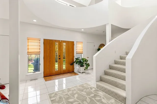 a view of an entryway with wooden floor and windows