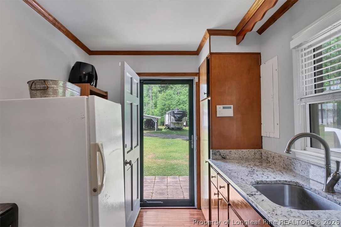 7266 Pleasant Hope Road Fairmont, NC 28340 - Photo 17 of 45 a kitchen with a refrigerator and a sink
