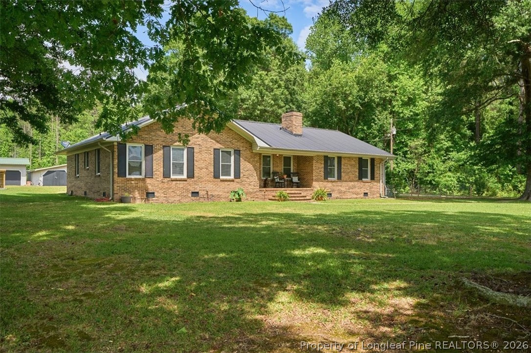 7266 Pleasant Hope Road Fairmont, NC 28340 - Photo 2 of 45 a front view of a house with a garden