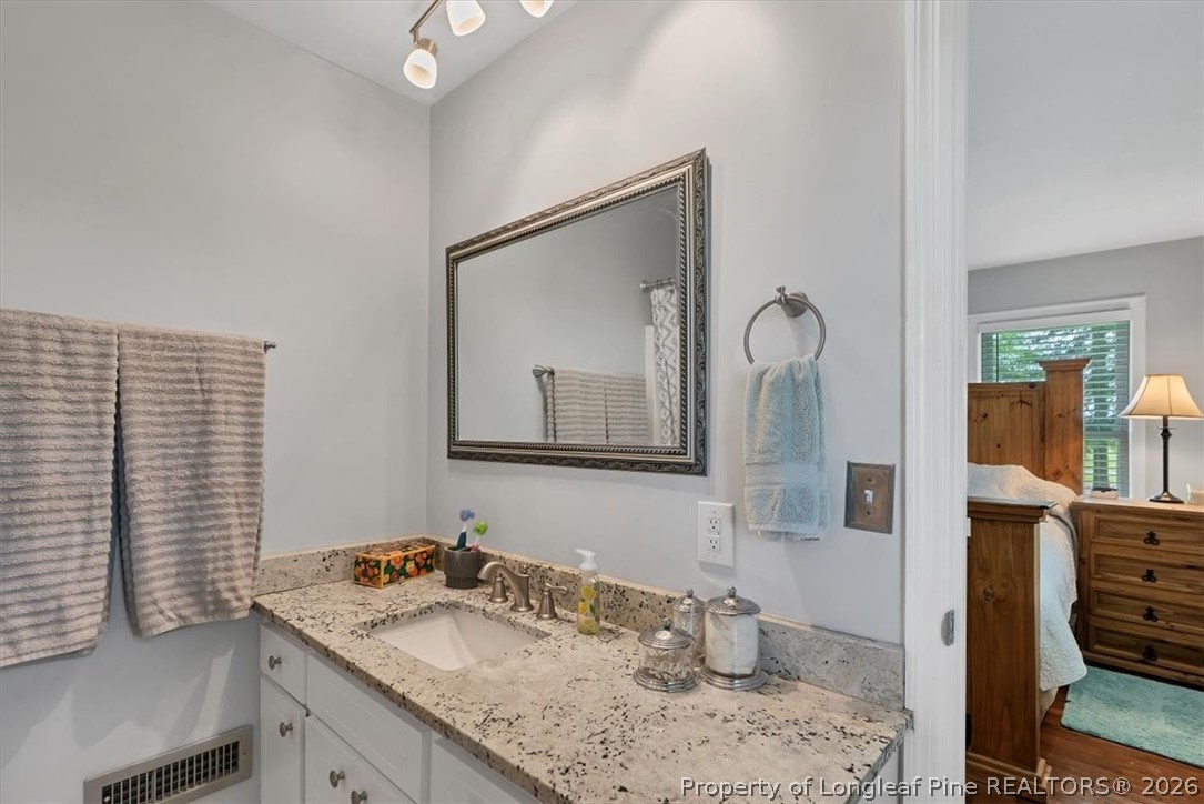 7266 Pleasant Hope Road Fairmont, NC 28340 - Photo 22 of 45 a bathroom with a granite countertop sink and a mirror