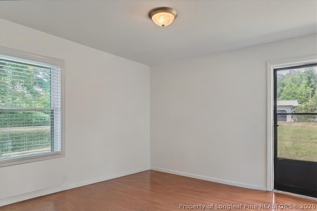7266 Pleasant Hope Road Fairmont, NC 28340 - Photo 24 of 45 a view of empty room with window and hardwood floor