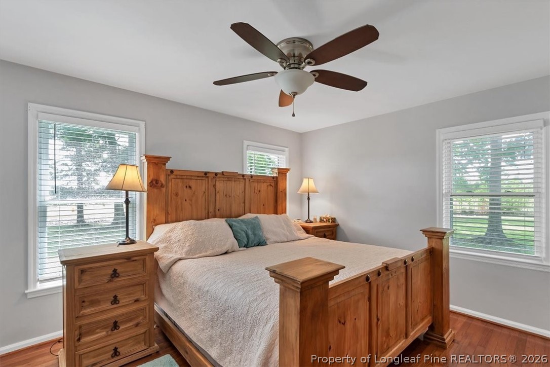 7266 Pleasant Hope Road Fairmont, NC 28340 - Photo 25 of 45 a bedroom with a bed and wooden floor