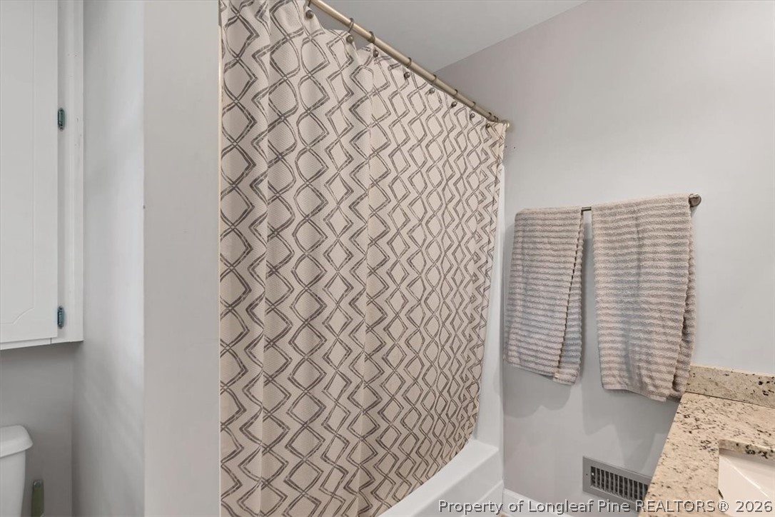 7266 Pleasant Hope Road Fairmont, NC 28340 - Photo 29 of 45 a bathroom with a shower curtain