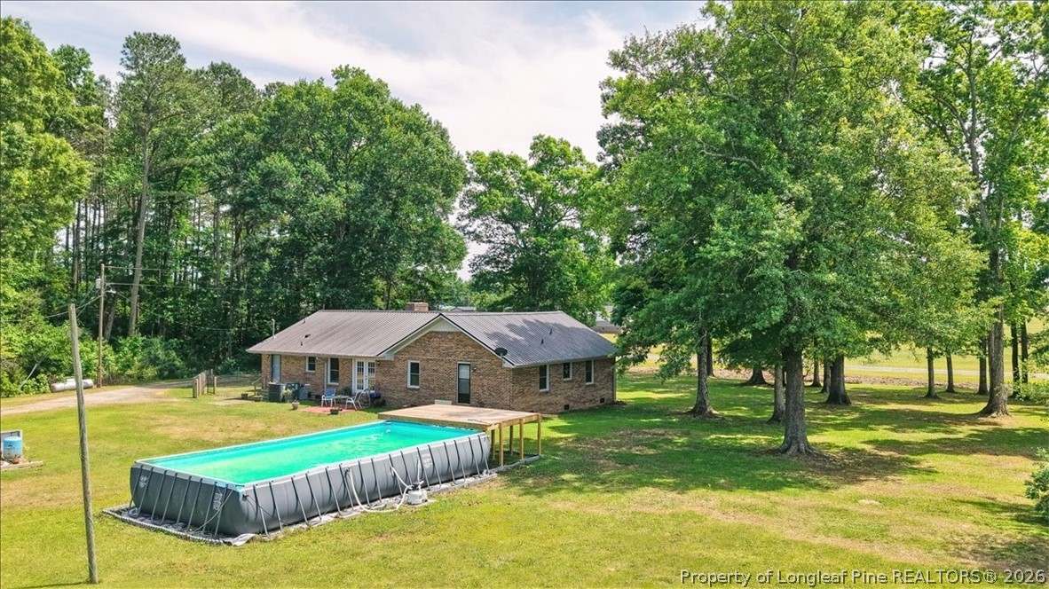 7266 Pleasant Hope Road Fairmont, NC 28340 - Photo 41 of 45 a view of a house with swimming pool and next to a big yard