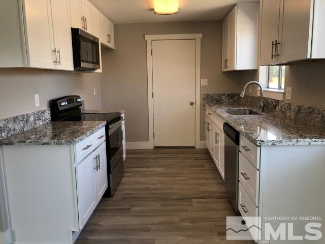 500 Nancy Circle Reno, NV 89503 - Photo 6 of 26 a kitchen with granite countertop a sink and a stove top oven