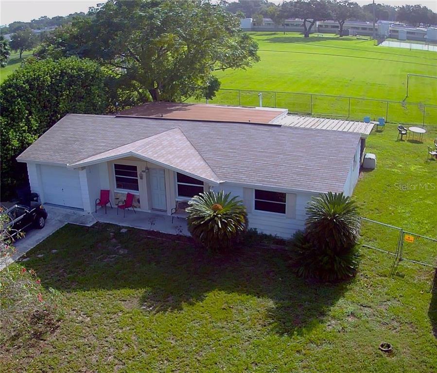 4439 Terry Loop New Port Richey, FL 34652 - Photo 1 of 1 a aerial view of a house with swimming pool and a yard