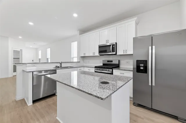 a stove top oven sitting inside of a kitchen