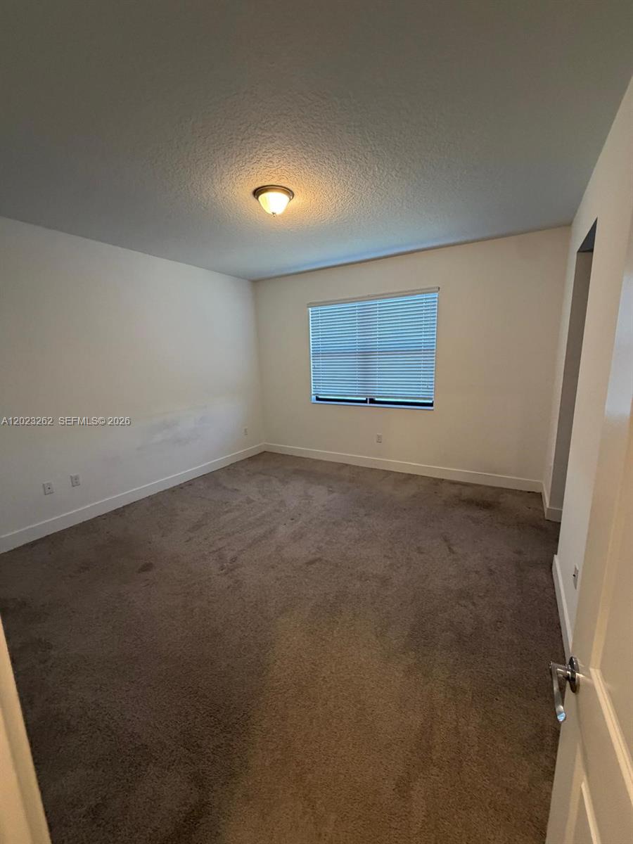 5669 Cerva Lane, Unit 5669 Immokalee, FL 34142 - Photo 21 of 32 an empty room with a empty space and window
