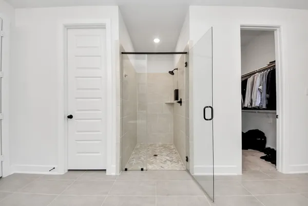 a view of a small space with wooden floor and a ceiling fan