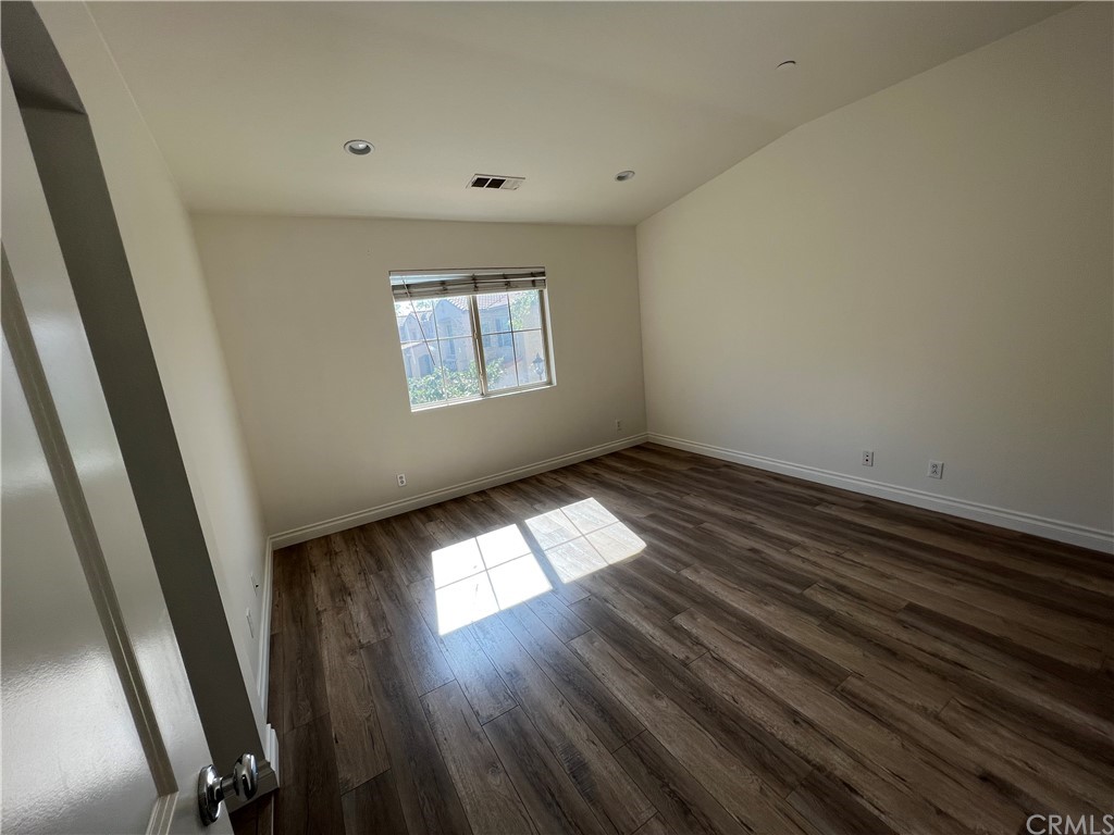 80 Hedge Bloom Irvine, CA 92618 - Photo 9 of 12 an empty room with wooden floor and windows