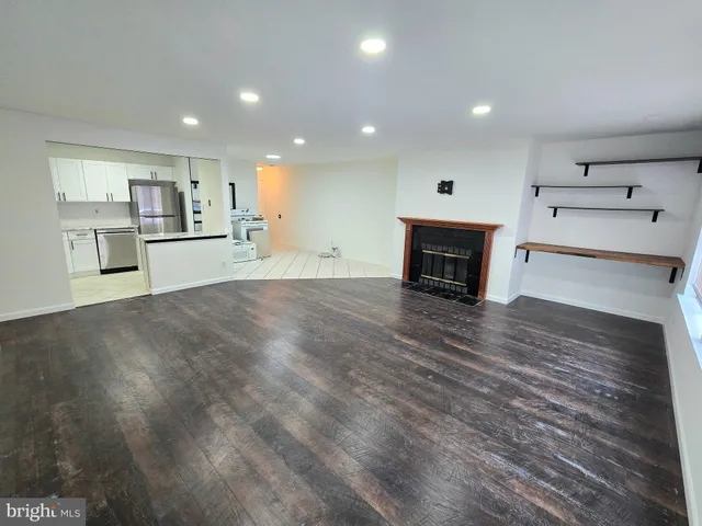 a view of a kitchen with cabinets and wooden floor