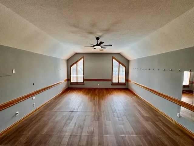 a bedroom with a bed and a ceiling fan