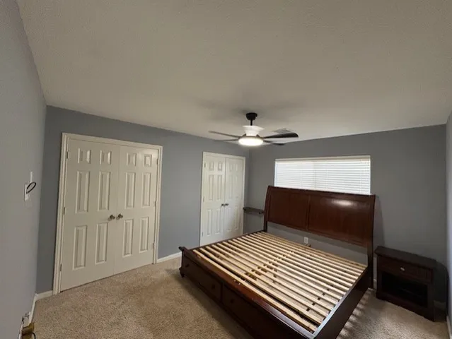 a spacious bathroom with a double vanity sink toilet and a mirror