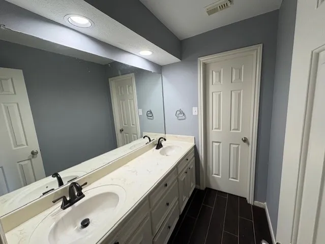 a living room with furniture and a ceiling fan