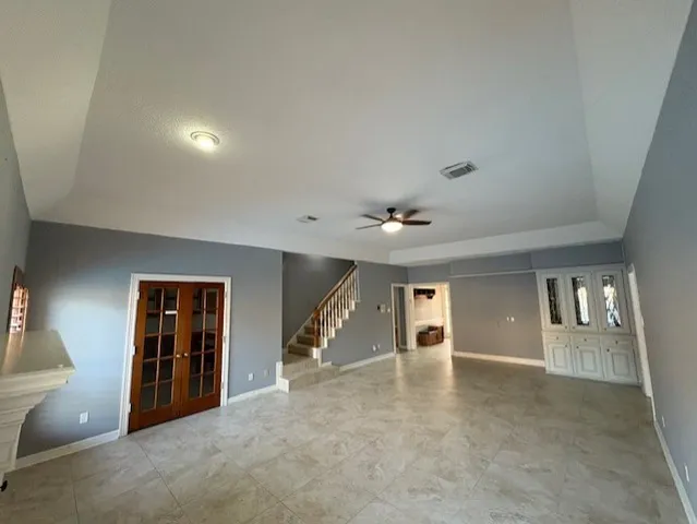 an empty room with windows and pillars in it