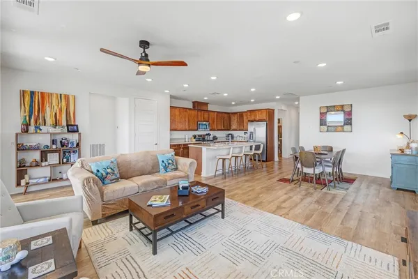 a large kitchen with kitchen island a stove a sink a refrigerator and cabinets