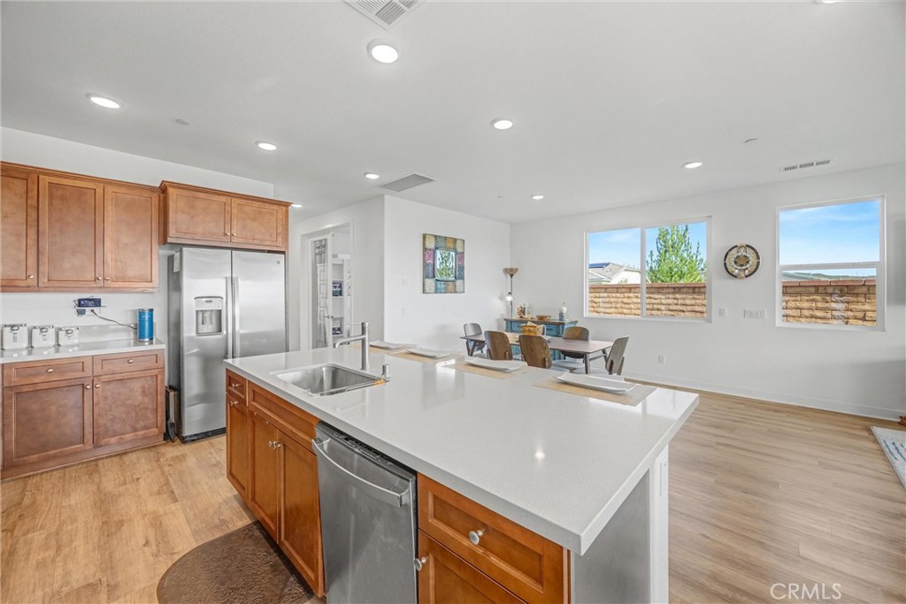 1685 Spring Run Lane Beaumont, CA 92223 - Photo 15 of 57 a kitchen with stainless steel appliances granite countertop a sink stove and refrigerator