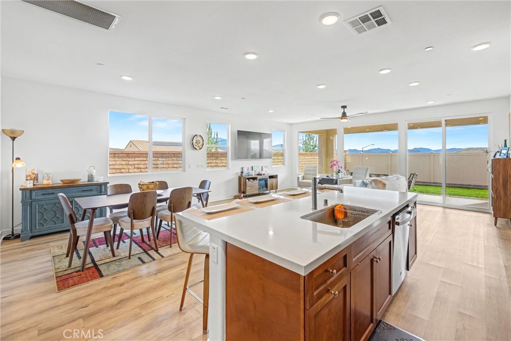1685 Spring Run Lane Beaumont, CA 92223 - Photo 16 of 57 a open kitchen with stainless steel appliances granite countertop a table and chairs