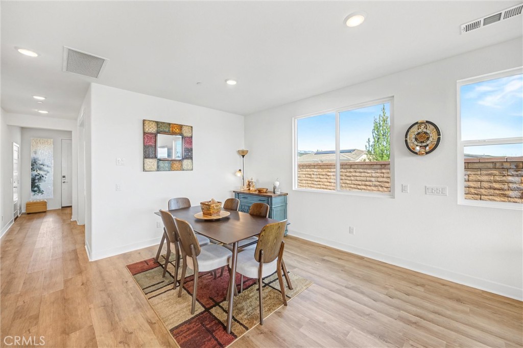 1685 Spring Run Lane Beaumont, CA 92223 - Photo 18 of 57 a view of a dining room with furniture and wooden floor
