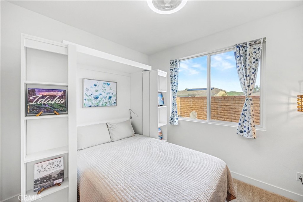1685 Spring Run Lane Beaumont, CA 92223 - Photo 22 of 57 a bedroom with a bed and a window