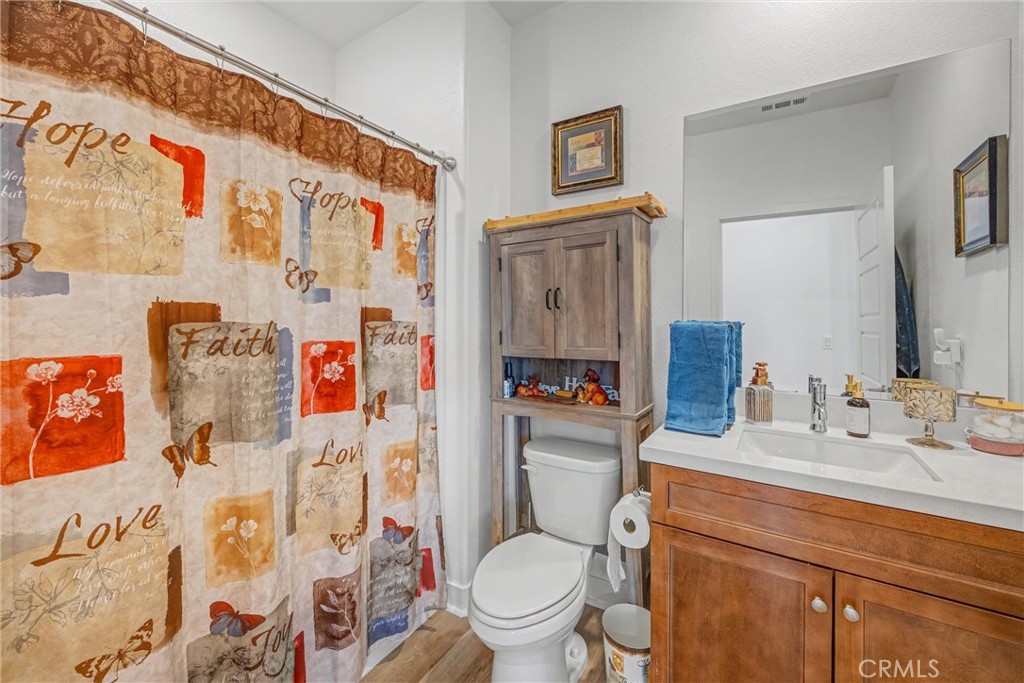 1685 Spring Run Lane Beaumont, CA 92223 - Photo 24 of 57 a bathroom with a toilet sink and mirror