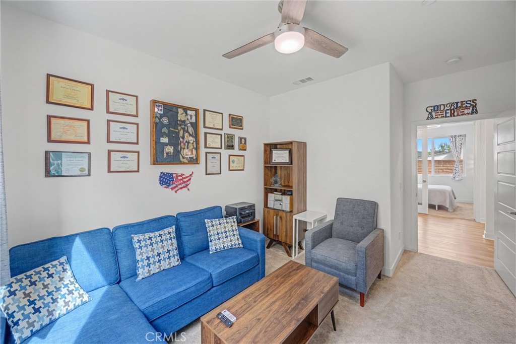 1685 Spring Run Lane Beaumont, CA 92223 - Photo 26 of 57 a living room with furniture and painting on the wall