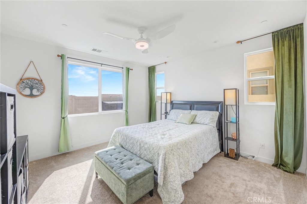 1685 Spring Run Lane Beaumont, CA 92223 - Photo 27 of 57 a bedroom with a bed and a table in it with window