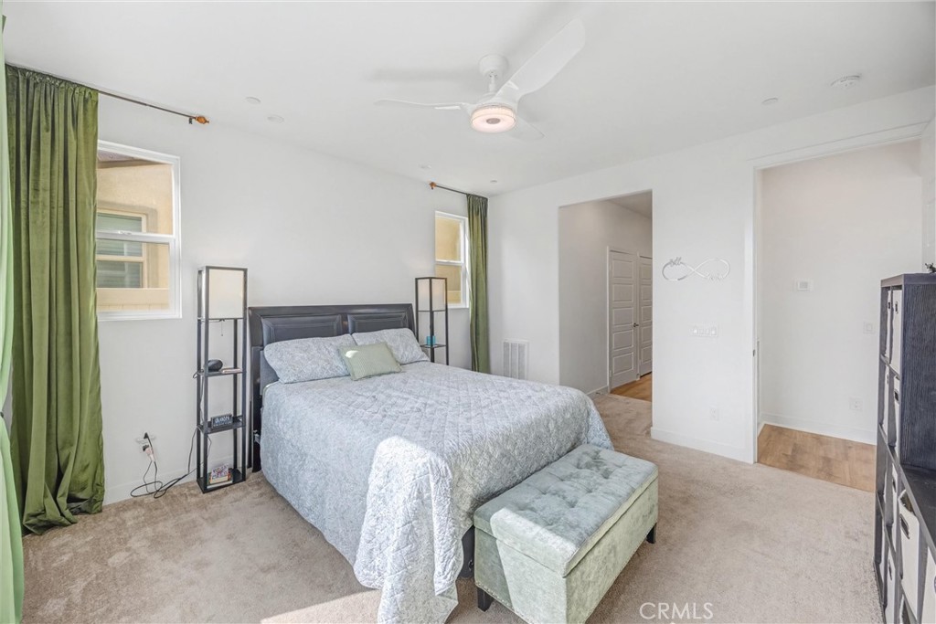 1685 Spring Run Lane Beaumont, CA 92223 - Photo 28 of 57 a bedroom with a bed and wooden floor