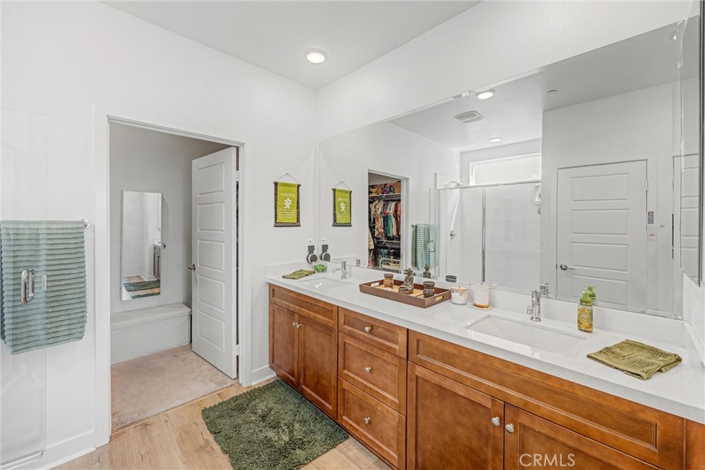1685 Spring Run Lane Beaumont, CA 92223 - Photo 30 of 57 a spacious bathroom with a granite countertop sink mirror and shower