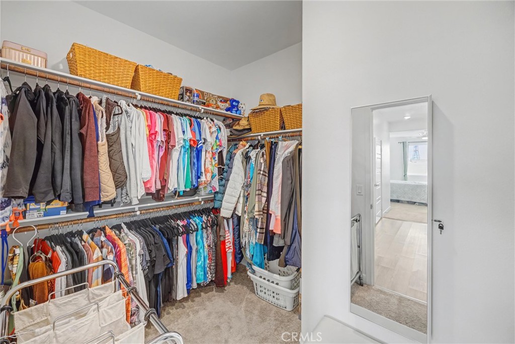 1685 Spring Run Lane Beaumont, CA 92223 - Photo 32 of 57 a view of walk in closet with clothes