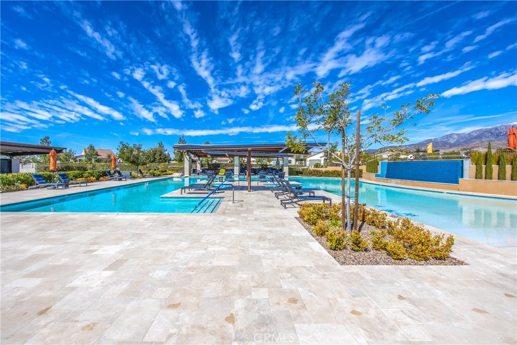 1685 Spring Run Lane Beaumont, CA 92223 - Photo 47 of 57 a view of a swimming pool with an outdoor space and seating area