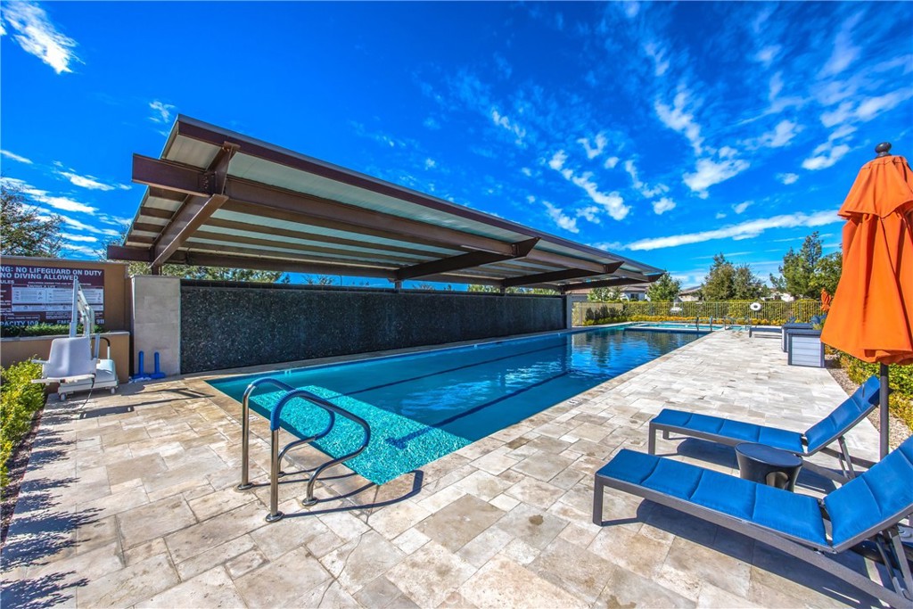 1685 Spring Run Lane Beaumont, CA 92223 - Photo 48 of 57 a roof deck with table and chairs under an umbrella with wooden floor