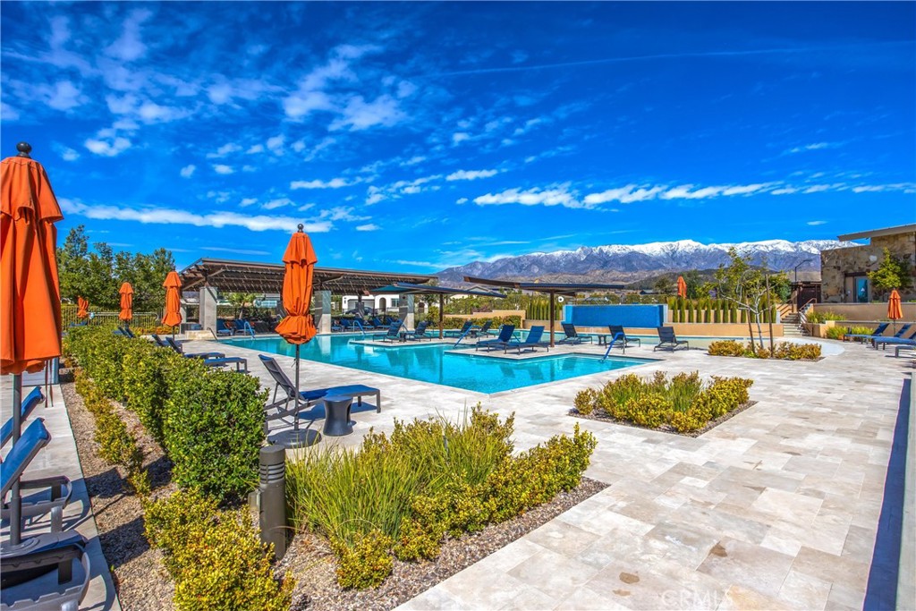 1685 Spring Run Lane Beaumont, CA 92223 - Photo 49 of 57 a view of a swimming pool with an outdoor seating and a yard