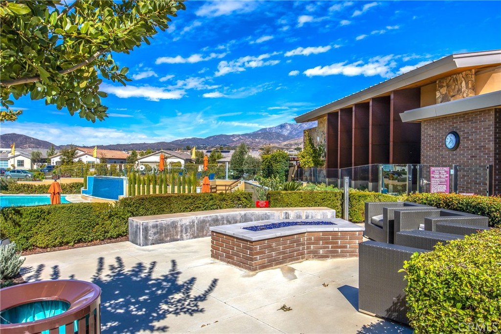 1685 Spring Run Lane Beaumont, CA 92223 - Photo 52 of 57 a view of a patio with couches table and chairs under an umbrella with a patio