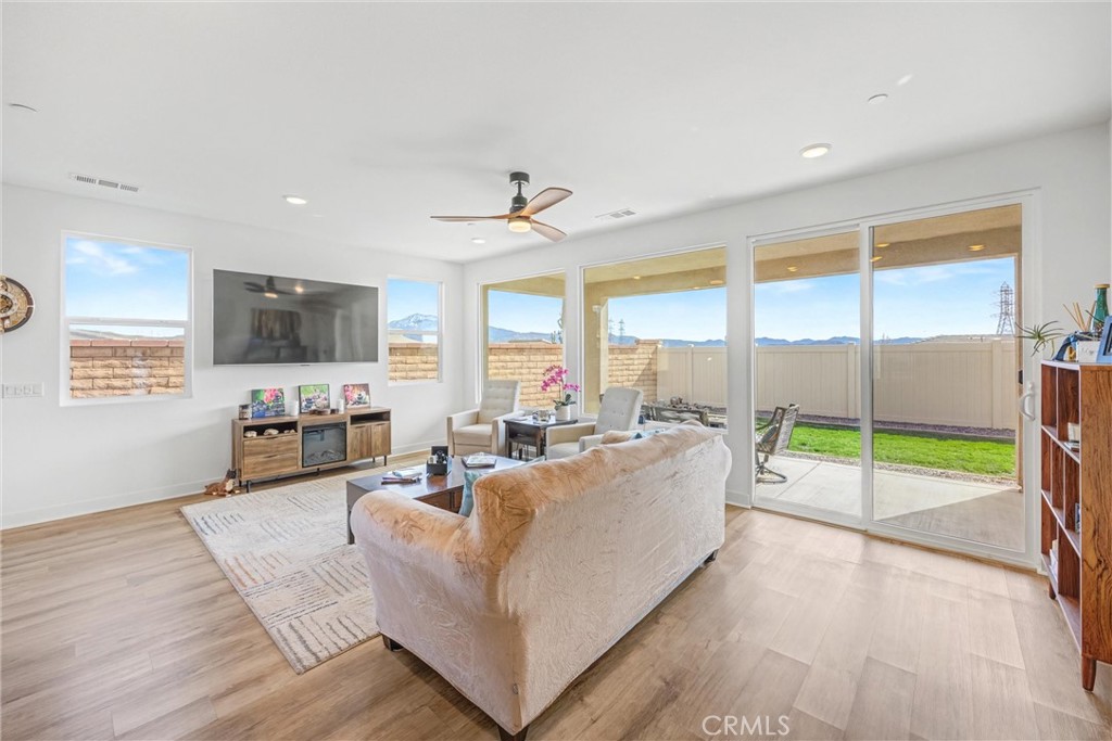 1685 Spring Run Lane Beaumont, CA 92223 - Photo 7 of 57 a living room with furniture and a flat screen tv
