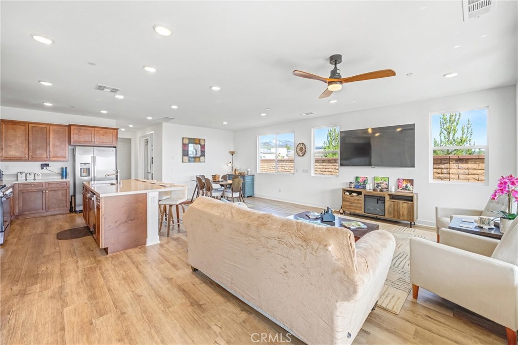 1685 Spring Run Lane Beaumont, CA 92223 - Photo 10 of 57 a living room with furniture and a flat screen tv