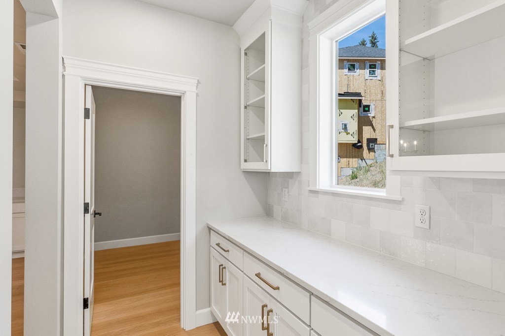 23027 30th Drive Southeast Bothell, WA 98021 - Photo 14 of 30 a kitchen with a white cabinets and a window