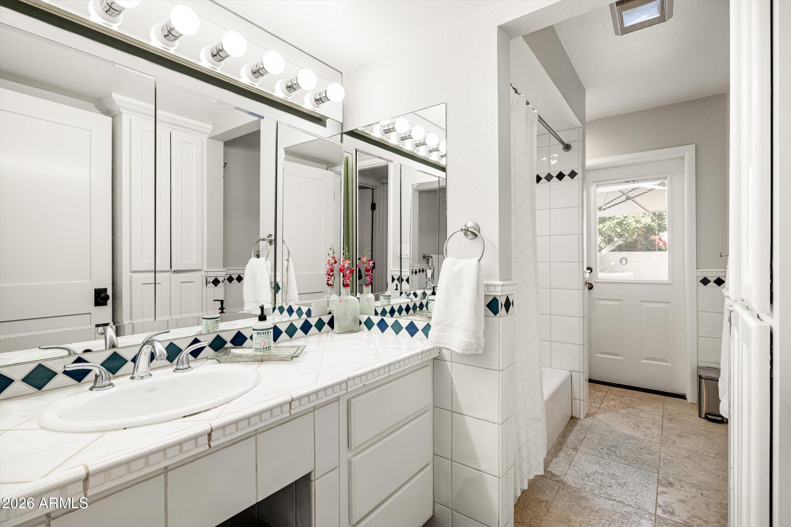 7142 North 14th Street Phoenix, AZ 85020 - Photo 19 of 29 a bathroom with a sink and a mirror