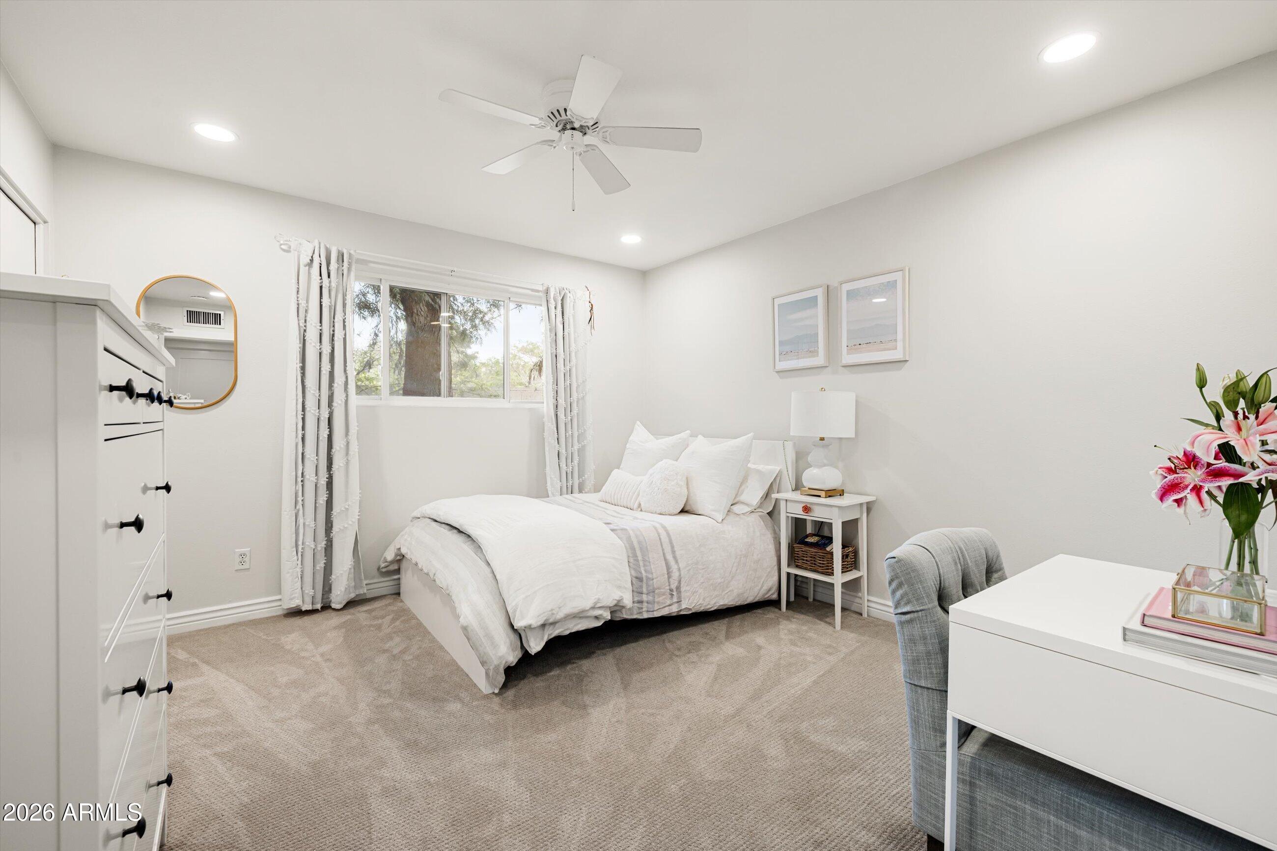 7142 North 14th Street Phoenix, AZ 85020 - Photo 20 of 29 a bed room with a bed and a chandelier
