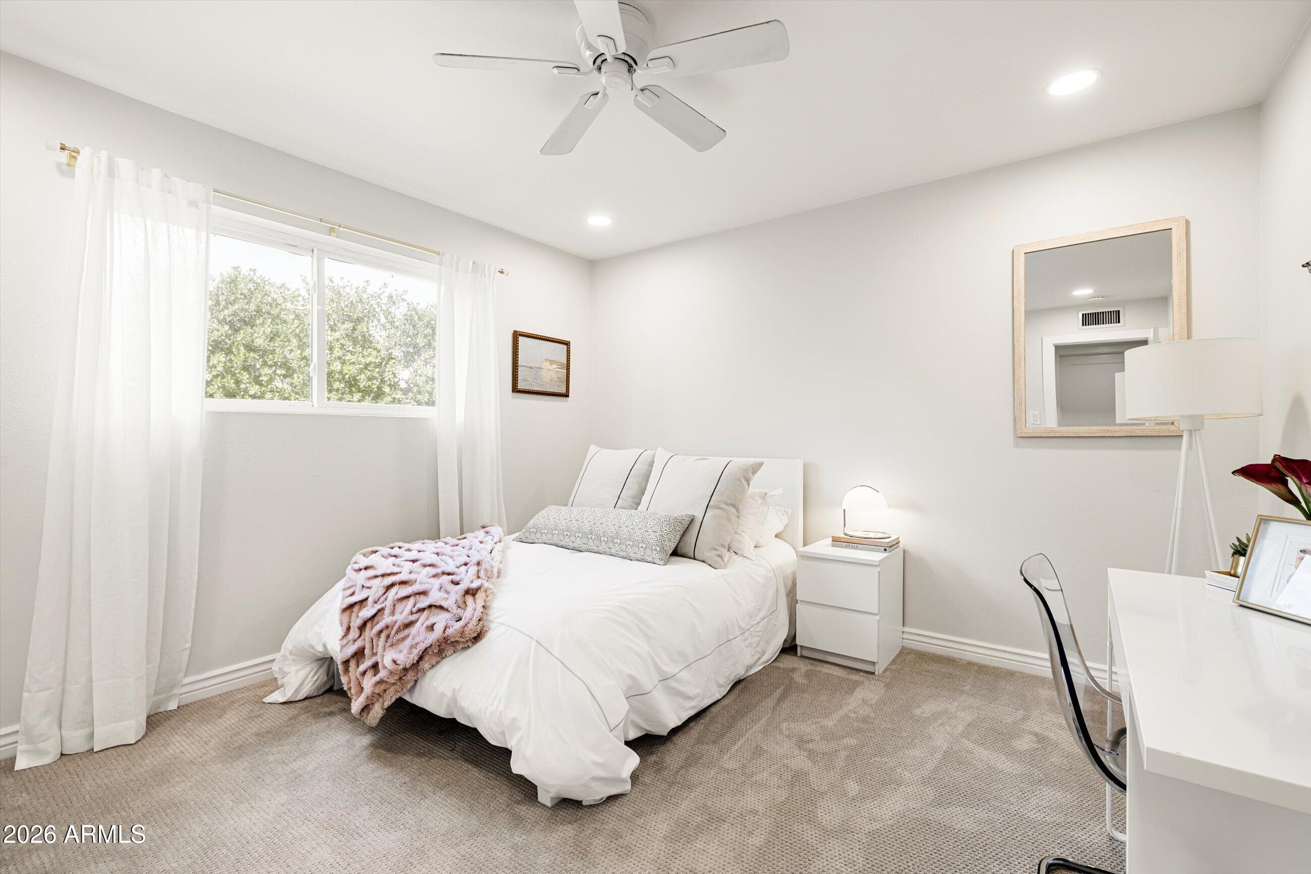 7142 North 14th Street Phoenix, AZ 85020 - Photo 21 of 29 a bedroom with a bed and a chandelier