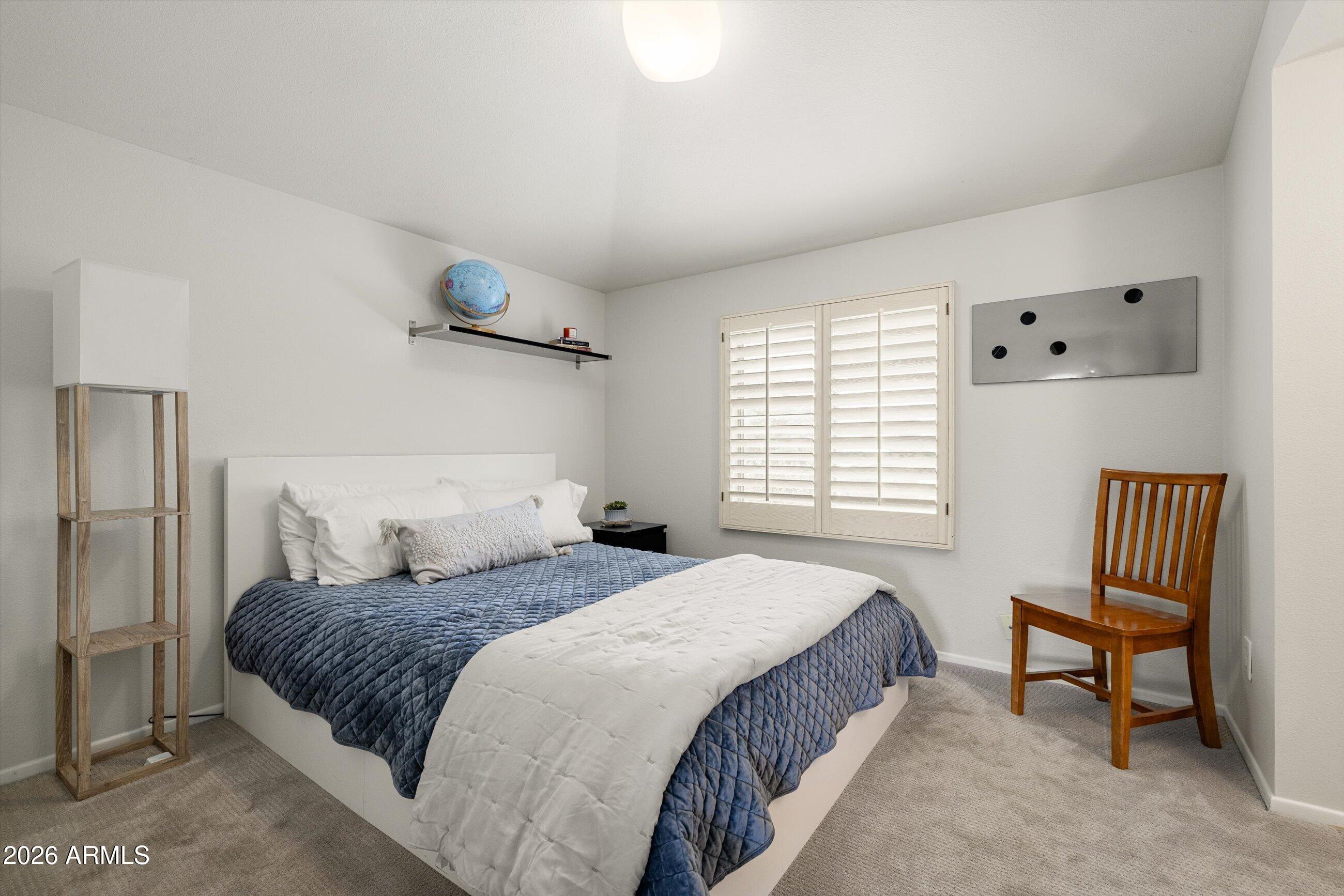 7142 North 14th Street Phoenix, AZ 85020 - Photo 23 of 29 a bedroom with a bed and a chair