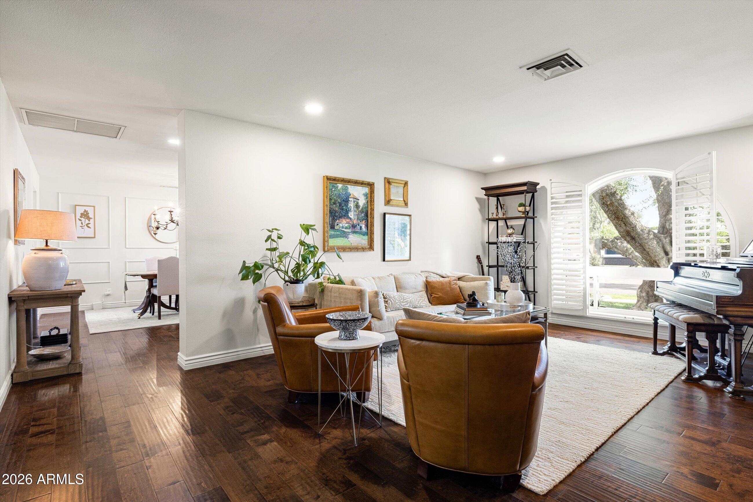 7142 North 14th Street Phoenix, AZ 85020 - Photo 6 of 29 a living room with furniture a wooden floor and a large window