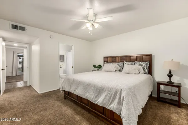 a bathroom with a sink a toilet and shower curtain