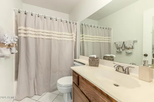 a kitchen with white cabinets and sink