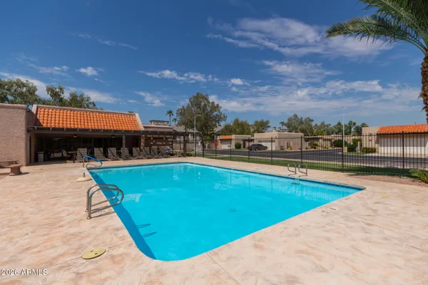 an outdoor space with swimming pool and furniture