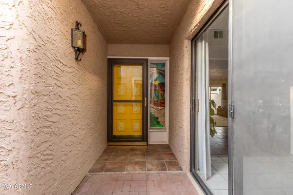 a balcony with table and chairs