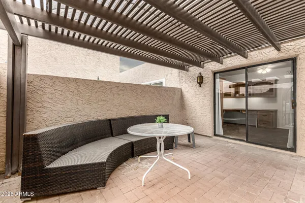 a outdoor patio with table and chairs