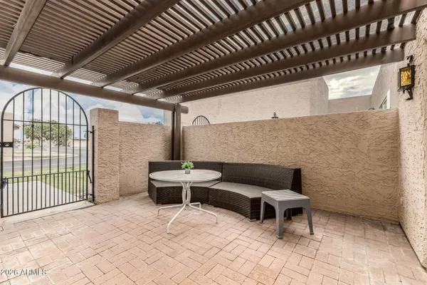 a outdoor patio with table and chairs