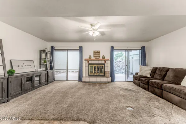 a living room with furniture and kitchen view